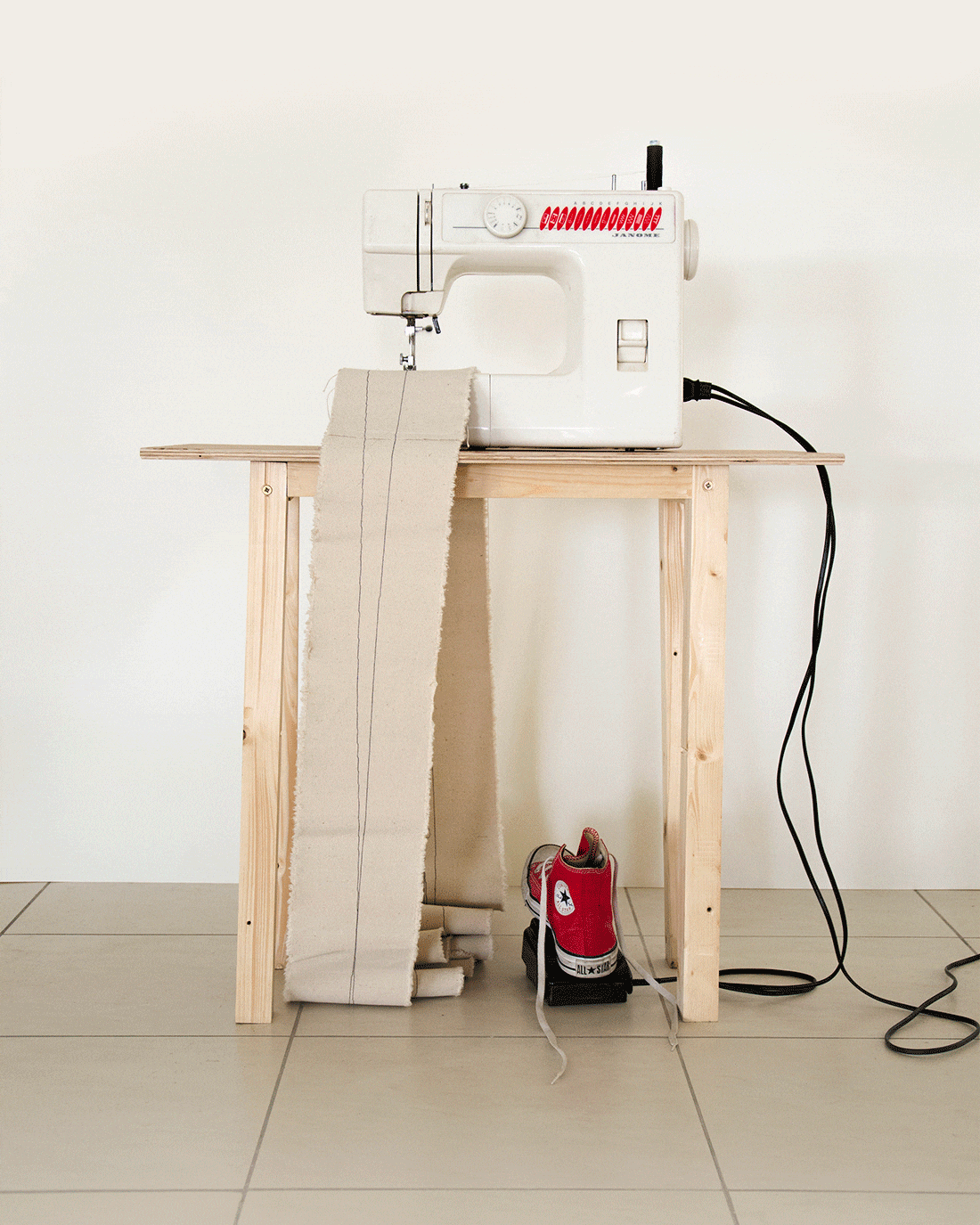 The installation consists of the artist's late grandmother sewing machine and the artist's shoe on the machine's pedal, sewing an endless loop of fabric. The installation represents two different generations, being the younger trying to follow the traditional line of an older generation.