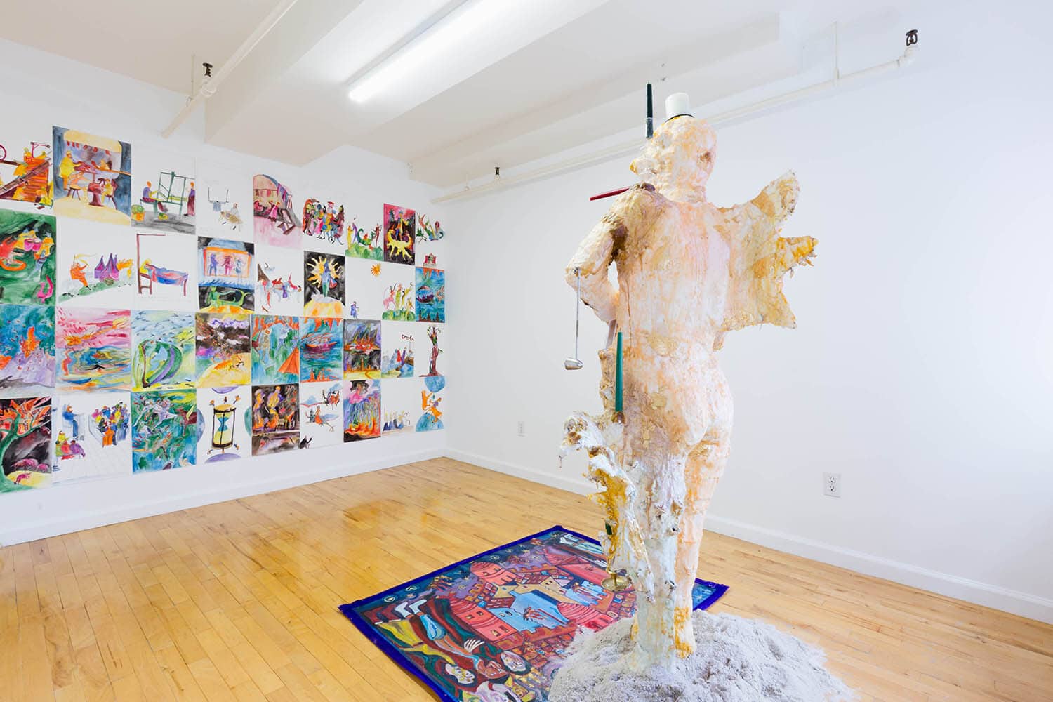 Illuminator centers itself around a sexless wing finned figure, embedded with candles and barnacles--a humanoid candelabra--dripping, melting and congealing fleshy, gilded wax, presiding over a floor painting depicting the Fall of Babylon as an upside down city from Bamberg Apocalypse 1000 A.D. Working within the liminal space of pictures and words, Illuminator draws on imagery produced by anonymous authors of medieval manuscripts.
