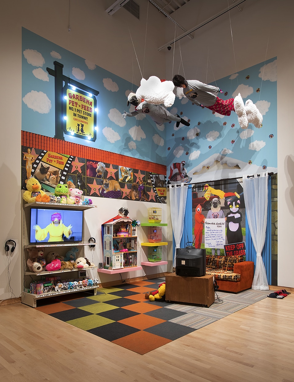 As part of “The Autotopographers” group exhibition at the John Michael Kohler Arts Center in Sheboygan, Wisconsin, we see split between a pet store and the family living room, "Daydream Reality" employing humor to tell the story of Yuki (daughter of the patriarch in the “KOKO’s Love” saga) and her quest for familial approval. The plot revolves around a dog that Yuki wants her father to buy for her. The pet store is Yuki’s dreamscape where her hoped-for dog lives. In contrast, handwritten notes, photographic murals, and mannequins hanging from the ceiling situate Yuki’s narrative in her reality: the family home. Together, the pet store and the family home in "Daydream Reality" reflect my life as a “1.5 generation Japanese Asian/Asian American” growing up in Los Angeles.