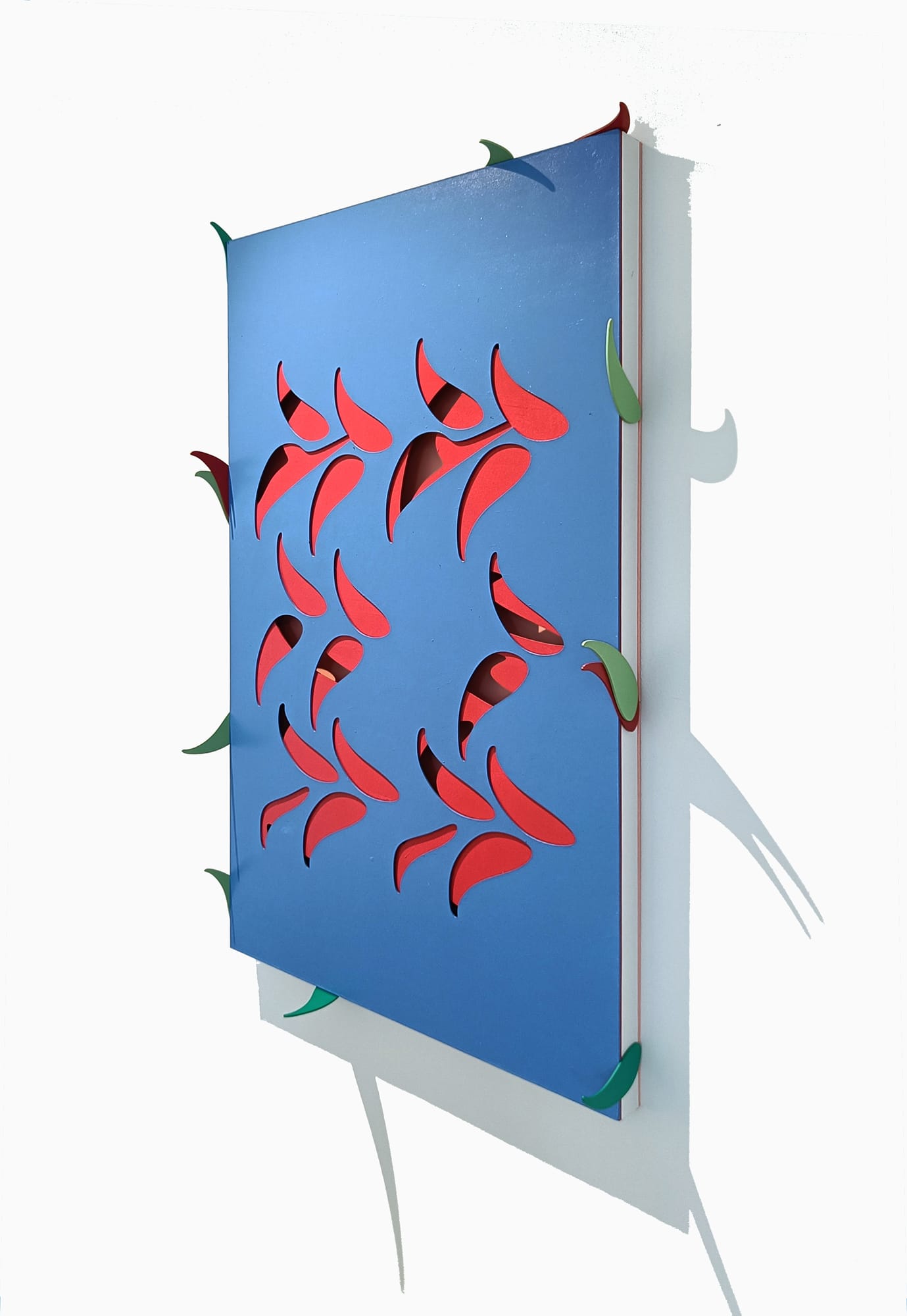 Art piece made of laser cut board, painted with soft blue and red