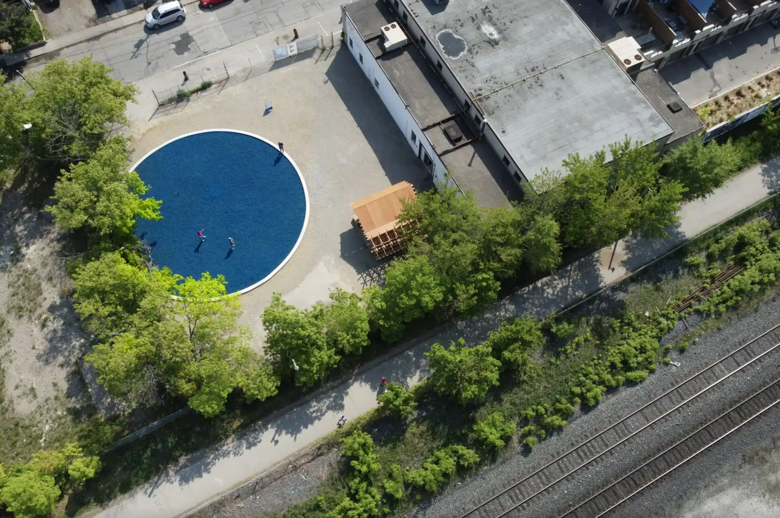 Forced Afloat is a public artwork consisting of thousands of square feet of blue rubber mulch, the kind commonly used in children’s playgrounds to slow movement, limit cuts and bruises, and cushion falls. When installed, the mulch’s azure-blue colour creates the illusion of a pool—a fake body of water—an association that is reinforced by the title. The mulch is made from recycled tires and is designed to invite play whilst also limiting movement to protect against injury. Rubber tires are sixty-percent synthetic and made from petroleum-derived hydrocarbons, which makes the mulch a contradiction in construction. Although it is framed as safe and environmentally sensitive, the material is packed with highly toxic chemical compounds and presents an insidious and underlying threat. Forced Afloat dispels the illusion of safety created by playgrounds and public spaces to reveal the invisible social contracts by which people accept limitations on their collective and individual freedoms—and sometimes ignore threats to the same. Forced Afloat was researched and developed while the artist was in residence at the Aga Khan Museum, Toronto; the residency was organized in partnership with the Delfina Foundation, London. At the Aga Khan, the mulch filled five large, reflective pools in front of the museum’s entrance and, although installed outdoors, the public was not allowed to touch or walk on it. When installed at the 2022 Toronto Biennial, the work was fully interactive, allowing members of the public to engage with it through touch and play. Depending upon where it is installed, and the different requirements of the museum hosting it, the work comes to symbolize either the projection of ideals of freedom and play or the challenges of institutional constraints and the rules that bind us from desired actions.