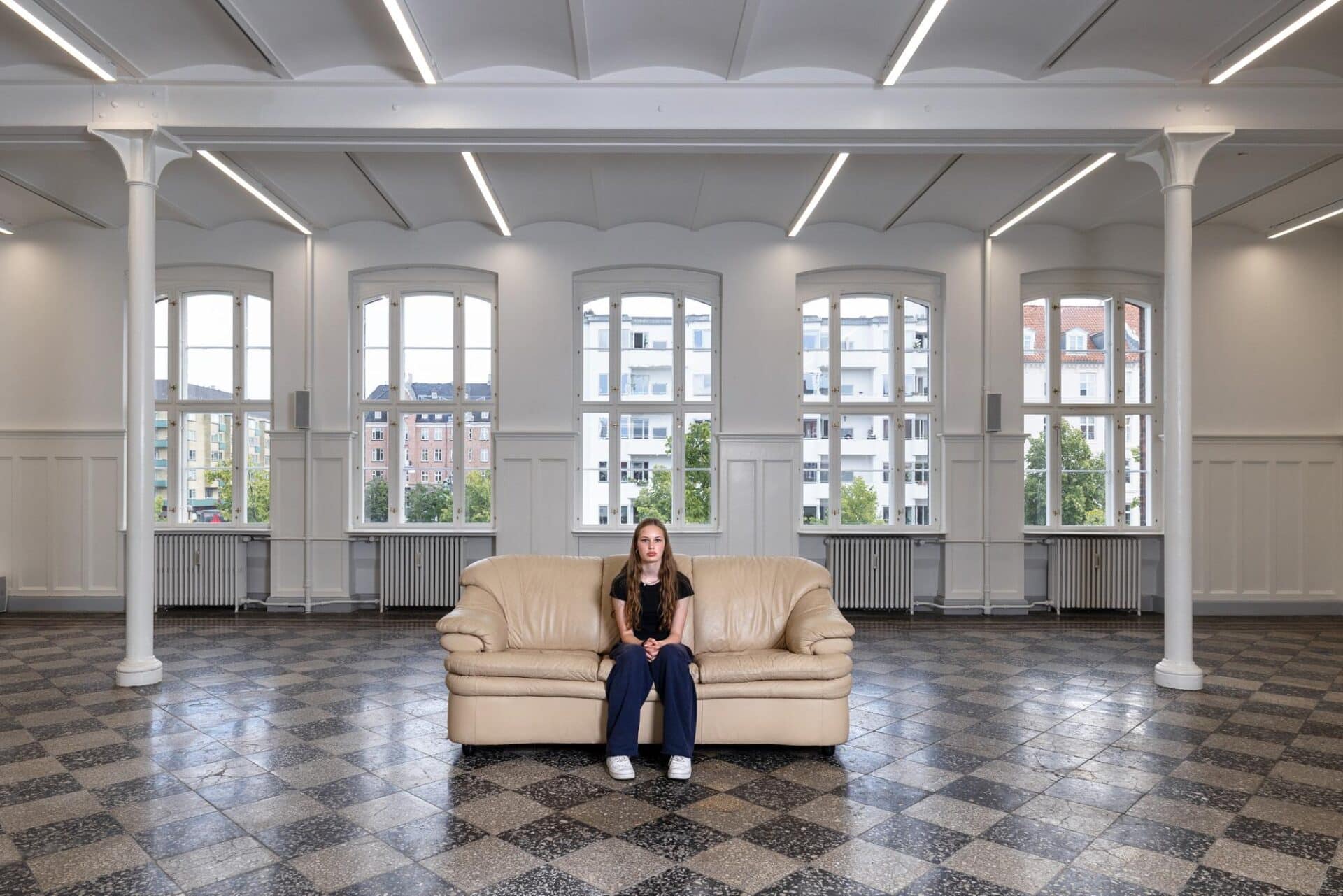 A teenager sitting alone on a sofa, singing their favorite song a cappella. For this final chapter, three teenagers took turns performing, each for four days.