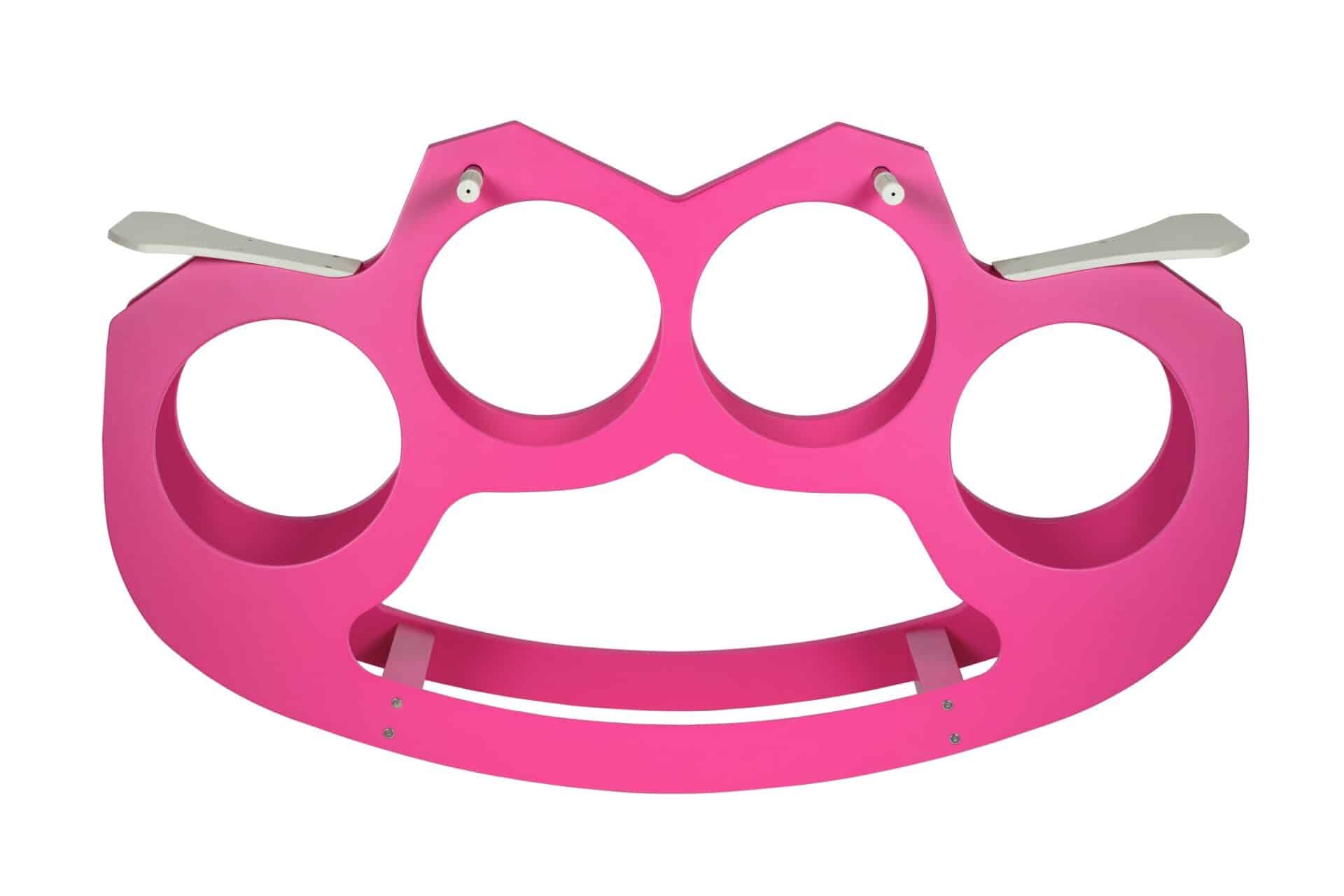 This work performs a radical semantic deconstruction of the brass knuckles, an object rooted in an aesthetic of violence and a masculine ritual of aggression. Through a functional transformation, the weapon relinquishes its coercive nature to become a rocking carousel: a playful device intended for the community. The use of pink and the reference to an aesthetic linked to femininity serve as acts of political subversion, claiming a space of transformative power capable of disarming the object. By replacing the practice of conflict with that of shared play, the work suggests a new relational architecture aimed at collective well-being and aesthetic joy.